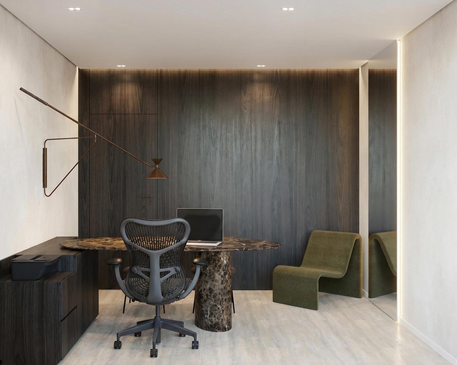 Consultório com painel de madeira escura, mesa de mármore com notebook, cadeira de trabalho e poltrona verde-oliva.