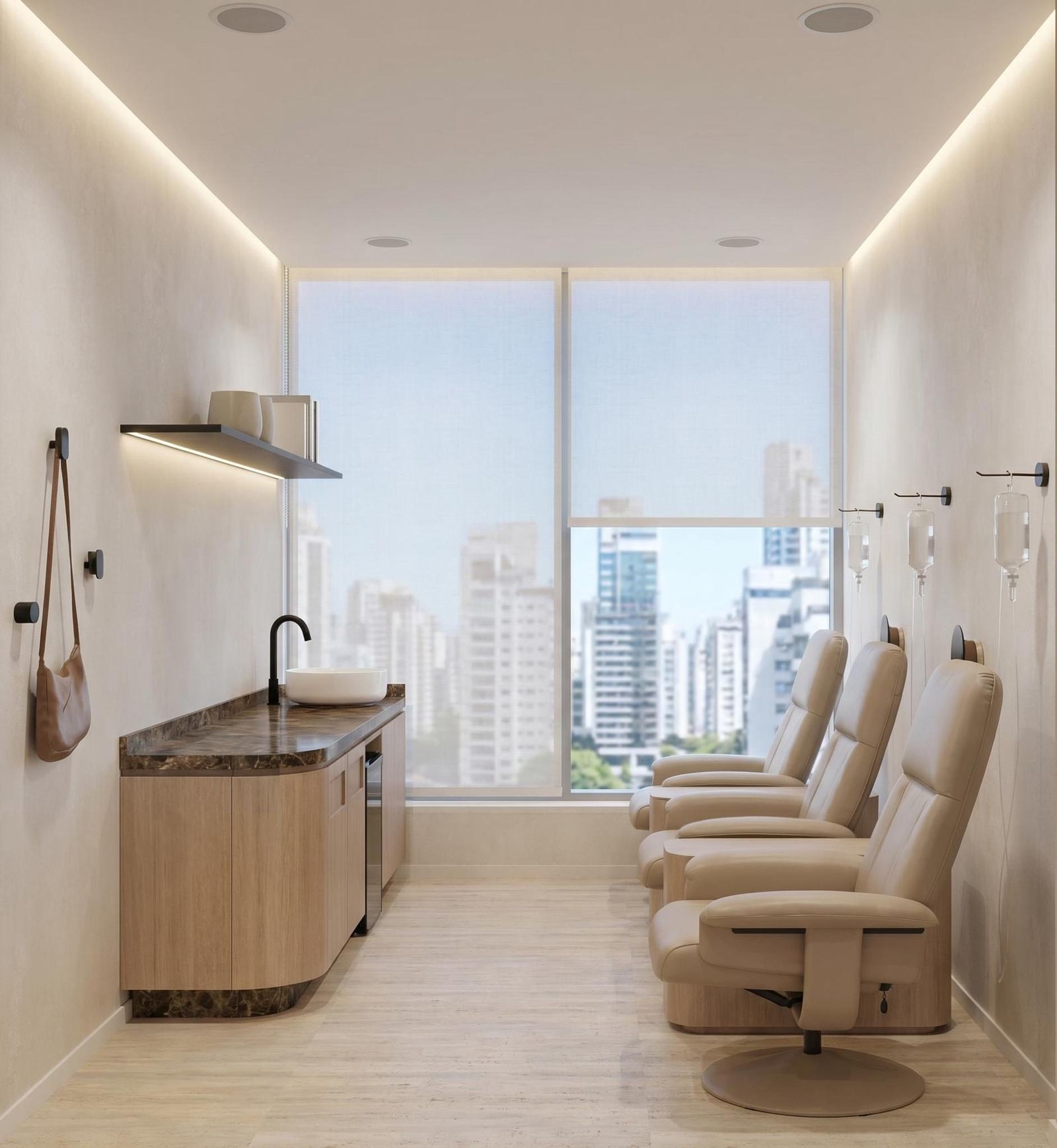 Sala de aplicação: poltronas reclináveis creme junto à janela, bancada de mármore marrom e painel de madeira clara.